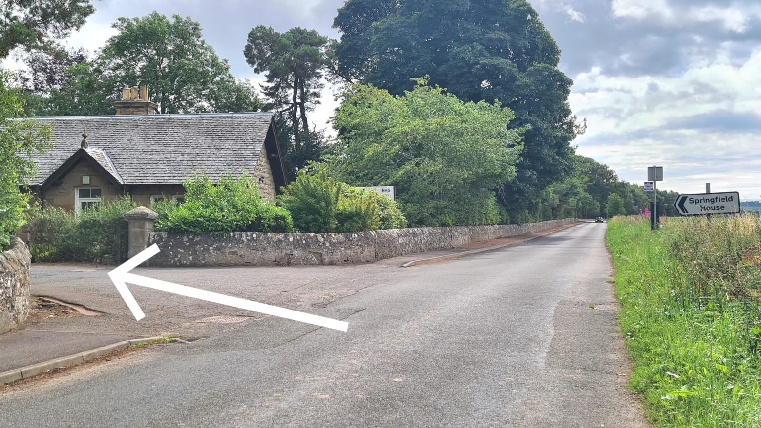 The same entrance seen from the opposite direction, marked with a white arrow